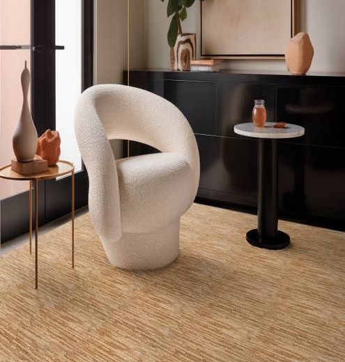 White chair and two small round tables sitting on Ambrose Maple carpet
