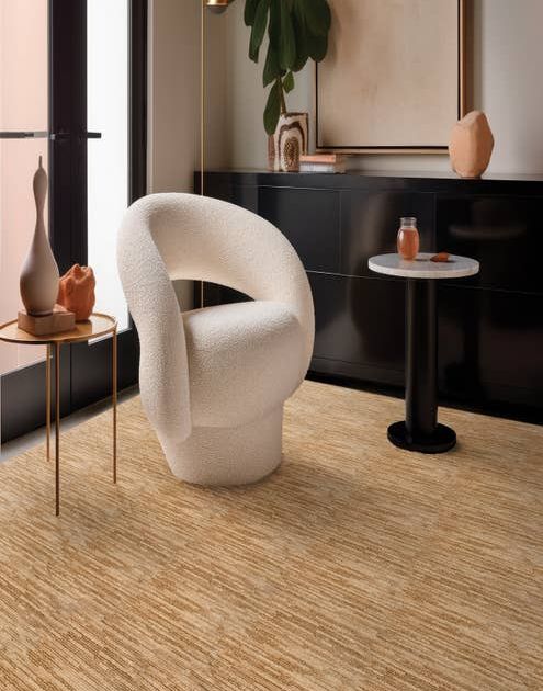 White chair and two small round tables sitting on Ambrose Maple carpet