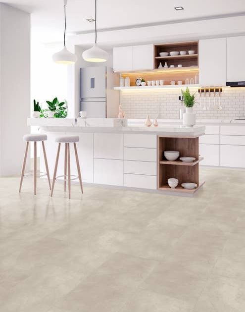 White modern kitchen with bright natural light, two stools by island, and cream stone/concrete look vinyl tiles