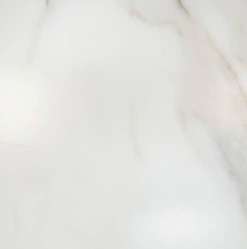 White marble look tile with faint gold and light gray veining throughout