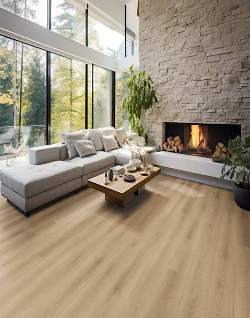 Spacious, natural, earthy living room with large stone fireplace, couch, and large floor-to-ceiling windows