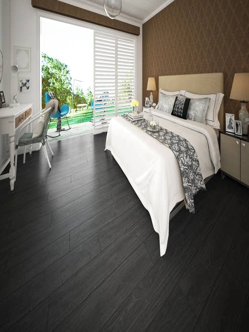 Bed and nightstands with small desk, opening up to porch with seating