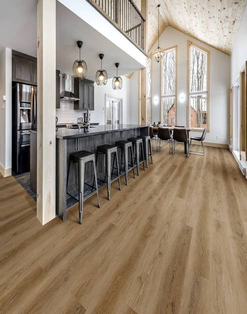 A-frame home interior featuring large windows and modern farmhouse kitchen and dining area, over Hartford Camel LVP flooring