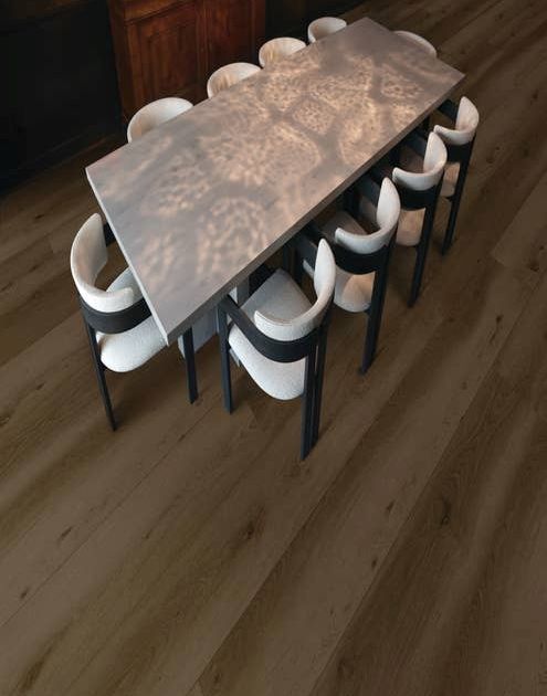 Gathering area with table and chairs, over warm, dark wide-plank Park City Grizzly floor