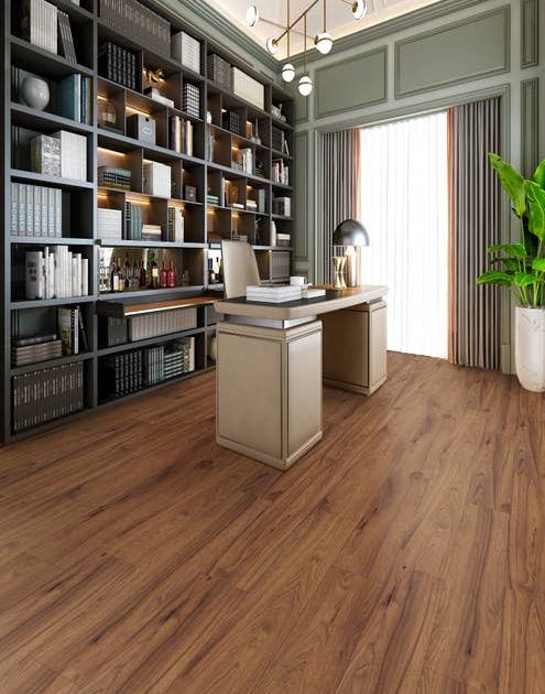Home office with large window, wainscoting, and built-in bookshelves, over a medium brown laminate floor