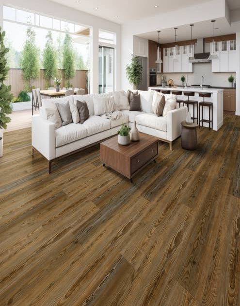 Open-concept living room, kitchen, and patio seating area furnished with contemporary pieces and a wide brown plank floor