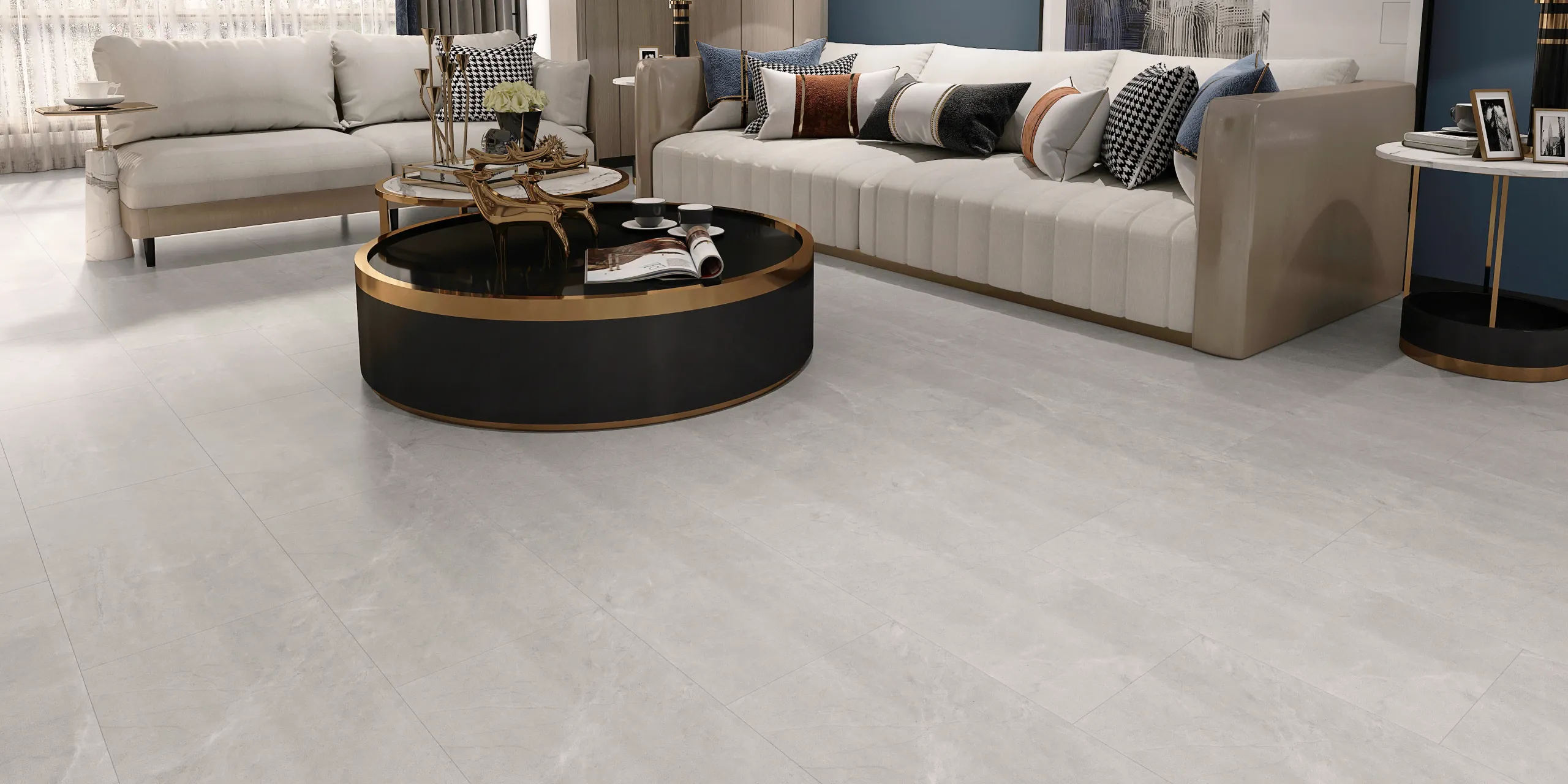 Luxe high-end living room with two sofas, black and gold coffee table, and two white and black side tables over light gray LVT floor