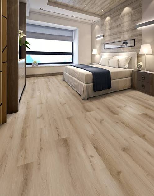 Bedroom with large black framed window, built-in dresser, light brown wood-look floor, and linear patterned wall behind bed