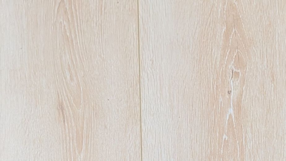 Sample of Beach House laminate showing a blonde woodgrain design with soft pink undertones, knots, and grain details