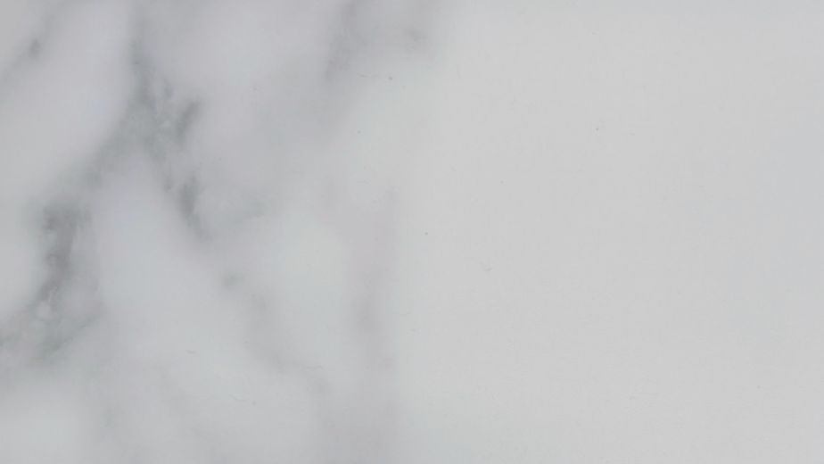 Sample of Calcutta Marble Pearl showing crisp white background and gray veining to mimic marble