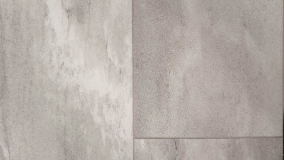 Sample of luxury sheet vinyl Roca Bone, a gray and taupe tinged stone design with off-white veining