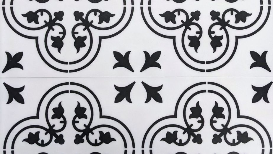 Valencia Aurora luxury vinyl tile featuring black and white gothic-inspired ironwork floral design