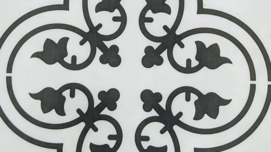 Sample of Valencia Aurora LVT showing black gothic, floral design on white background