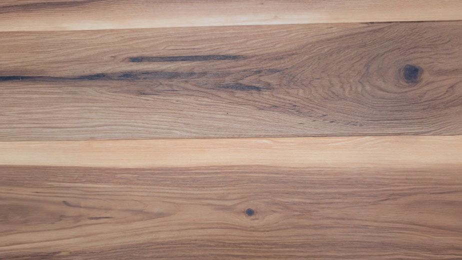 Smoked Amber LVP planks, showing high tonal variation and knots