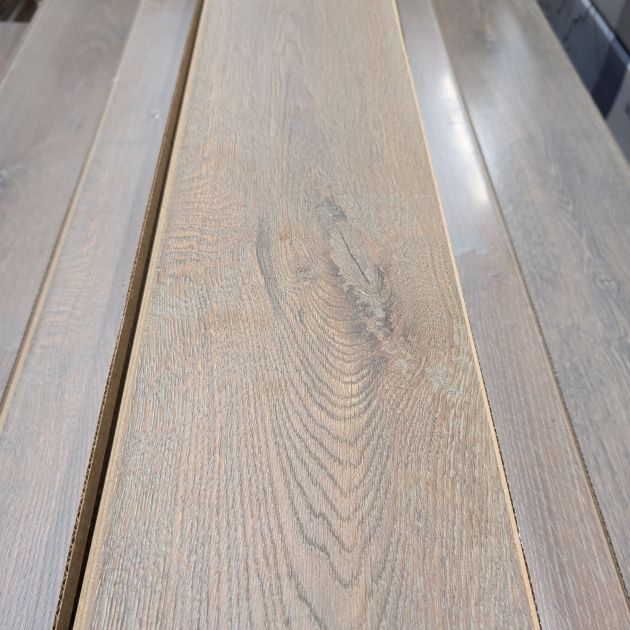 Tannin Oak laminate sample showing mid brown tones, golden undertones, and wood detailing