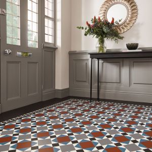 Front entry hall with gray wainscoting, table, mirror, and Victorian-inspired multicolor tile