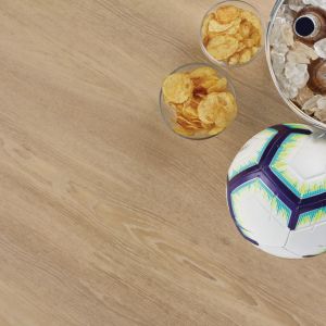 Soccer ball, chip cups, and beverages in ice bucket over taupe and beige woodgrain LVP floor