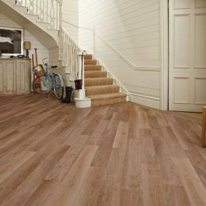 Hallway with shiplap walls, assorted vintage and athletic paraphernalia, and light brown floors installed at a diagonal and with a design border