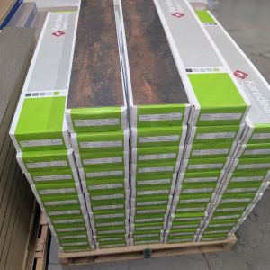 Pallet stacked with rectangular green and gray LVT cartons, with two Russus planks on top
