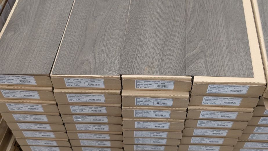 Pallet topped with columns of cardboard boxes of LVP Arbor